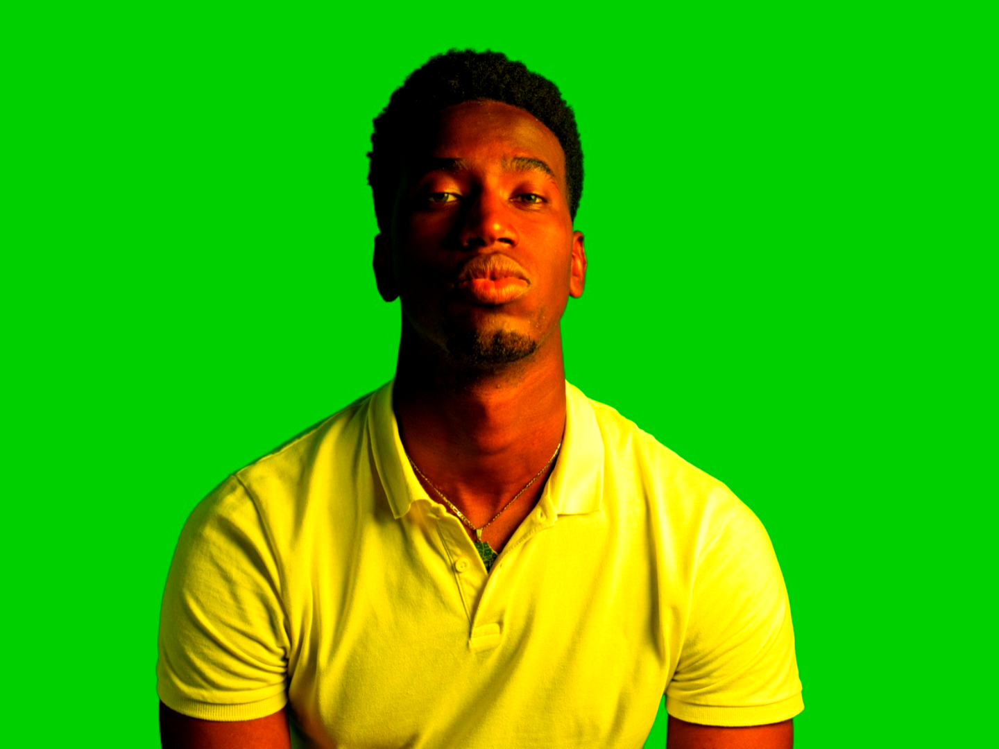A person in front of a green-screen backdrop with a vivid color grade