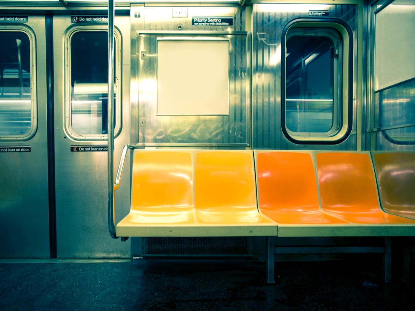 A city transit car interior with a cool color grade