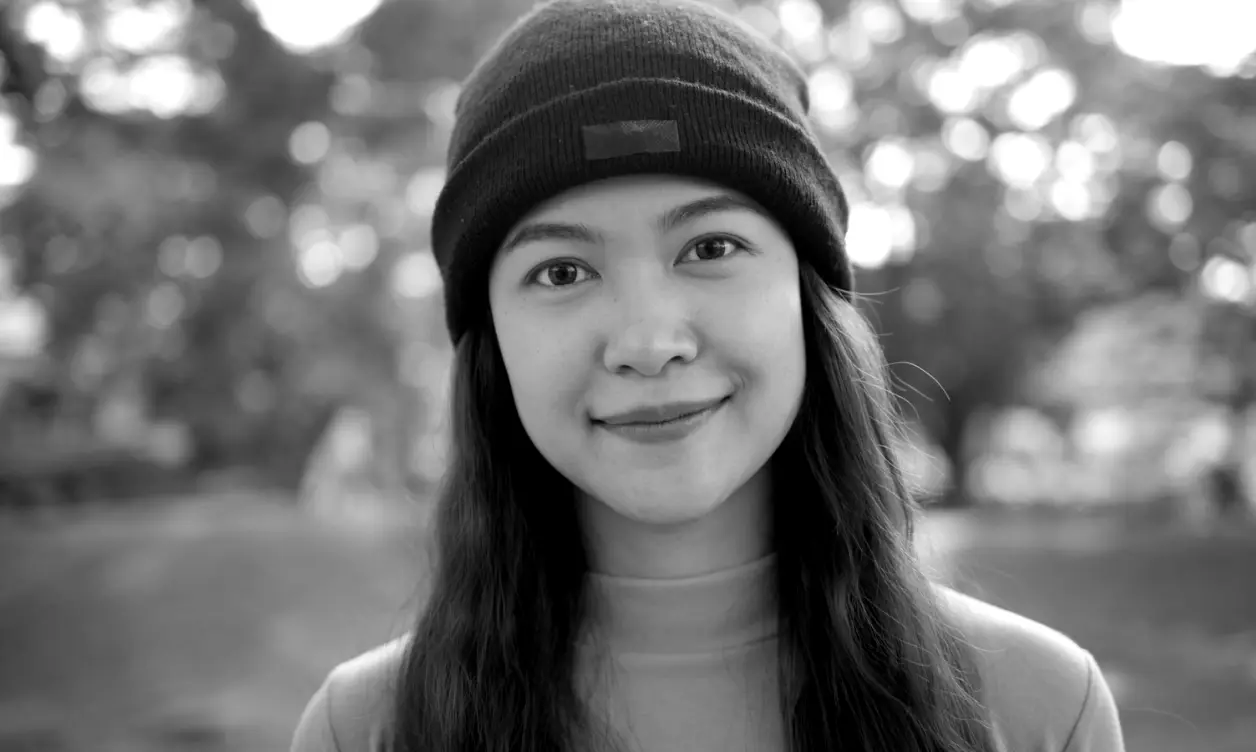 Creator filmed at eye level with moody black and white color grading