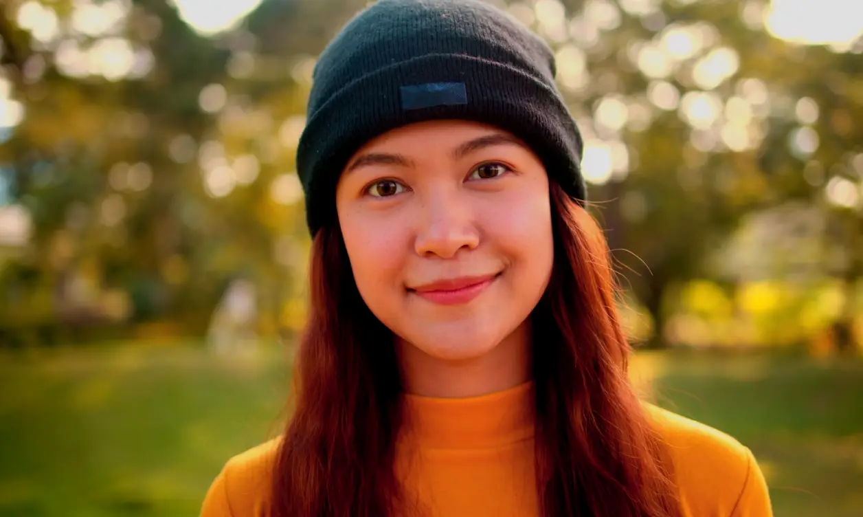 Creator filmed at eye level with bold, electric neon color grading