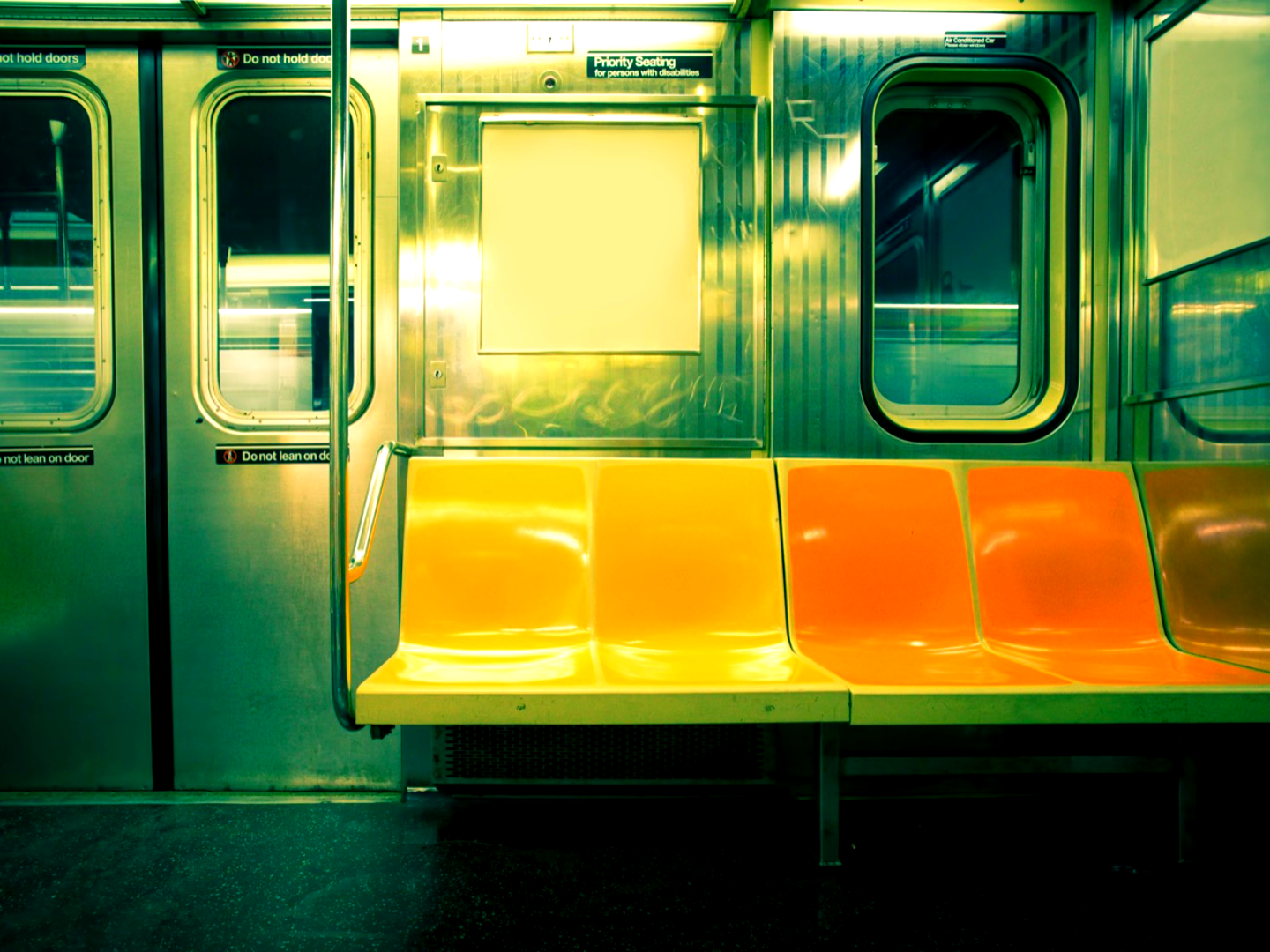 A city transit car interior with a vivid color grade