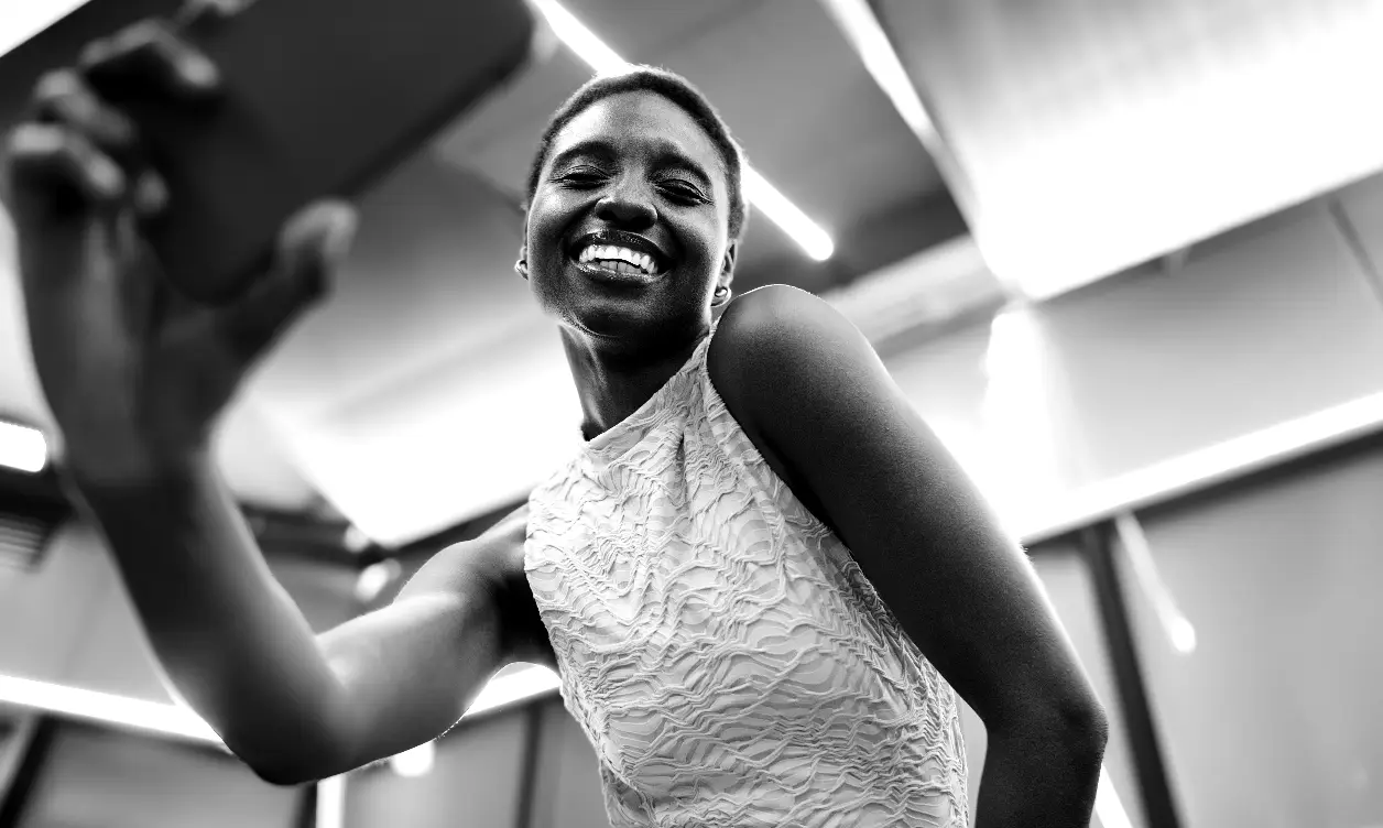 Creator filmed from three-quarter angle with moody black and white color grading