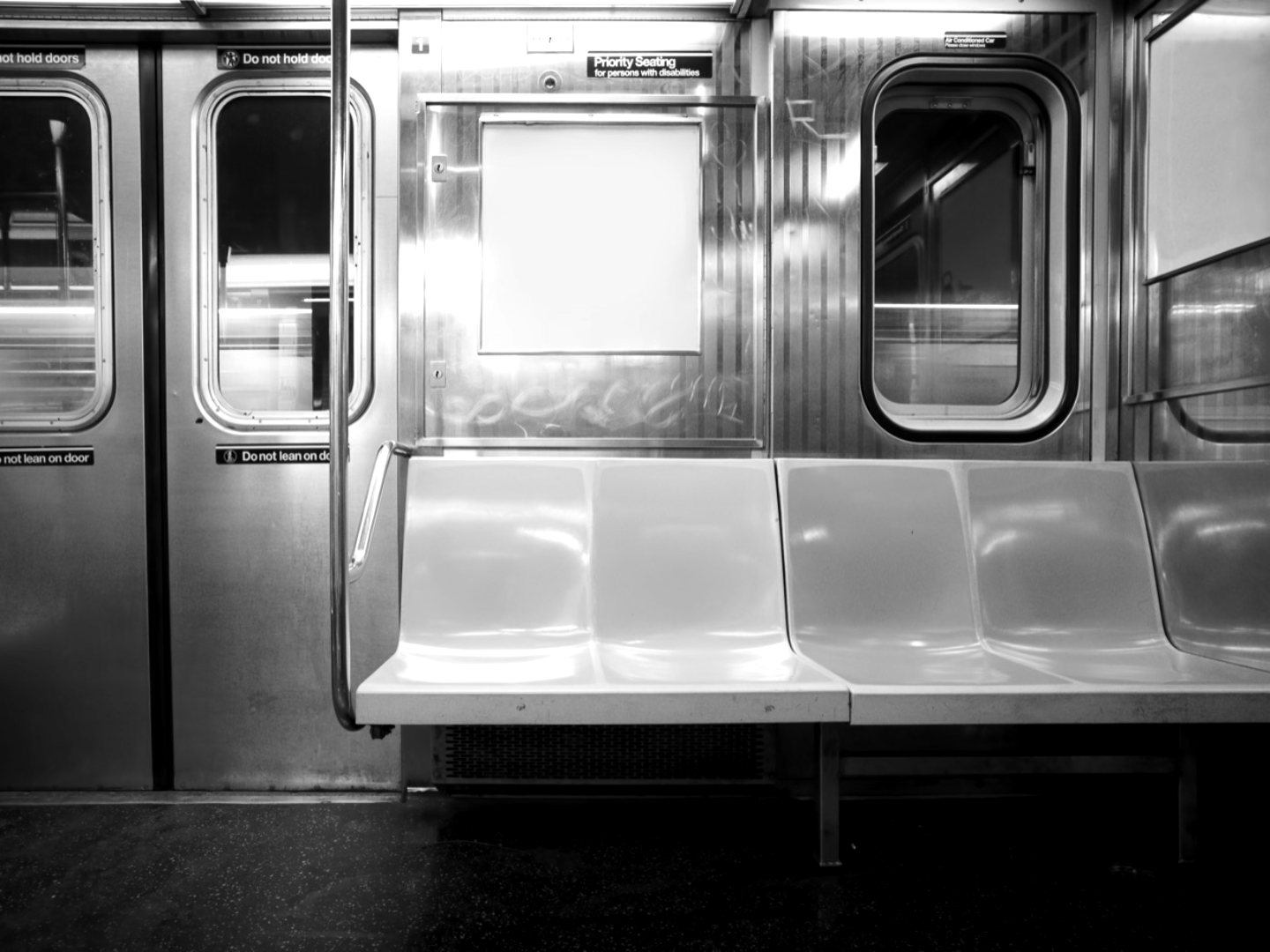 A city transit car interior in monochrome